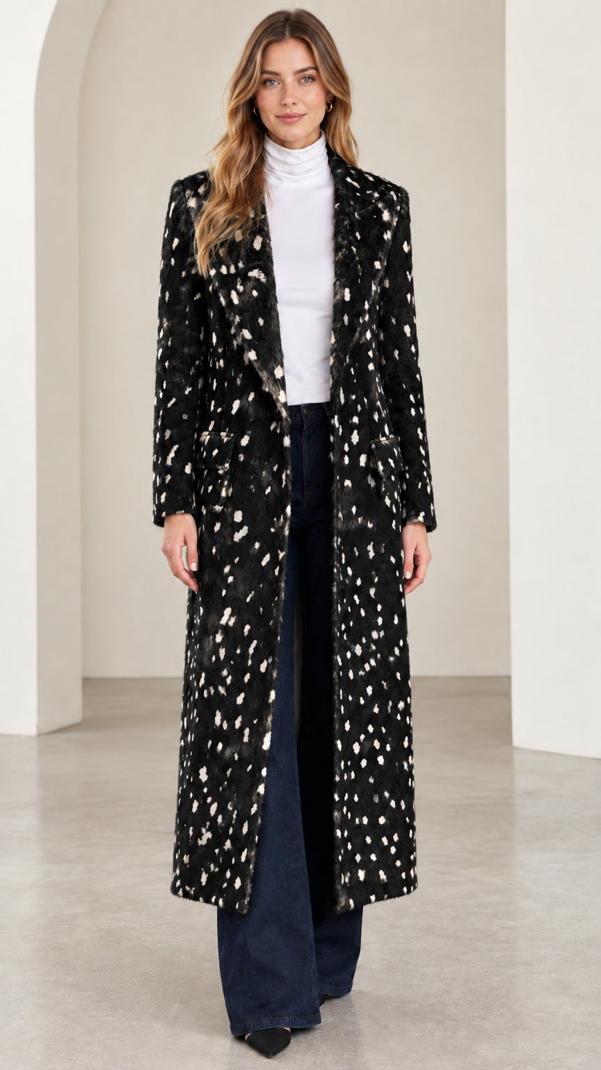 Front view of woman wearing black and white speckled tailored maxi coat