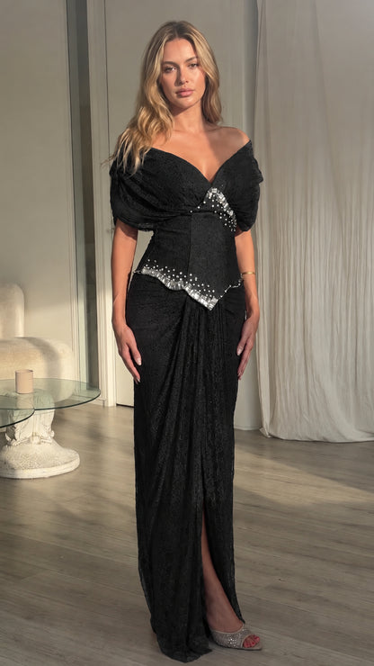 Front view of model wearing black off-the-shoulder embellished maxi dress