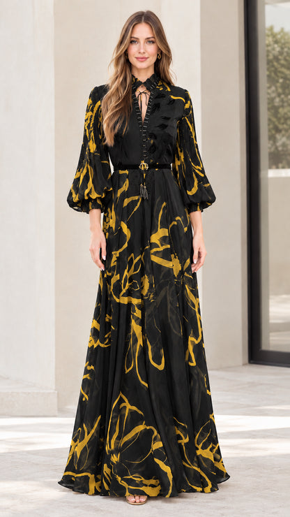 Model wearing black abstract print lantern sleeve belted maxi dress