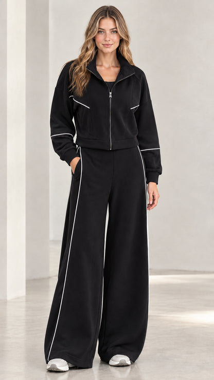 Front view of woman wearing black contrast piping zip-up tracksuit set