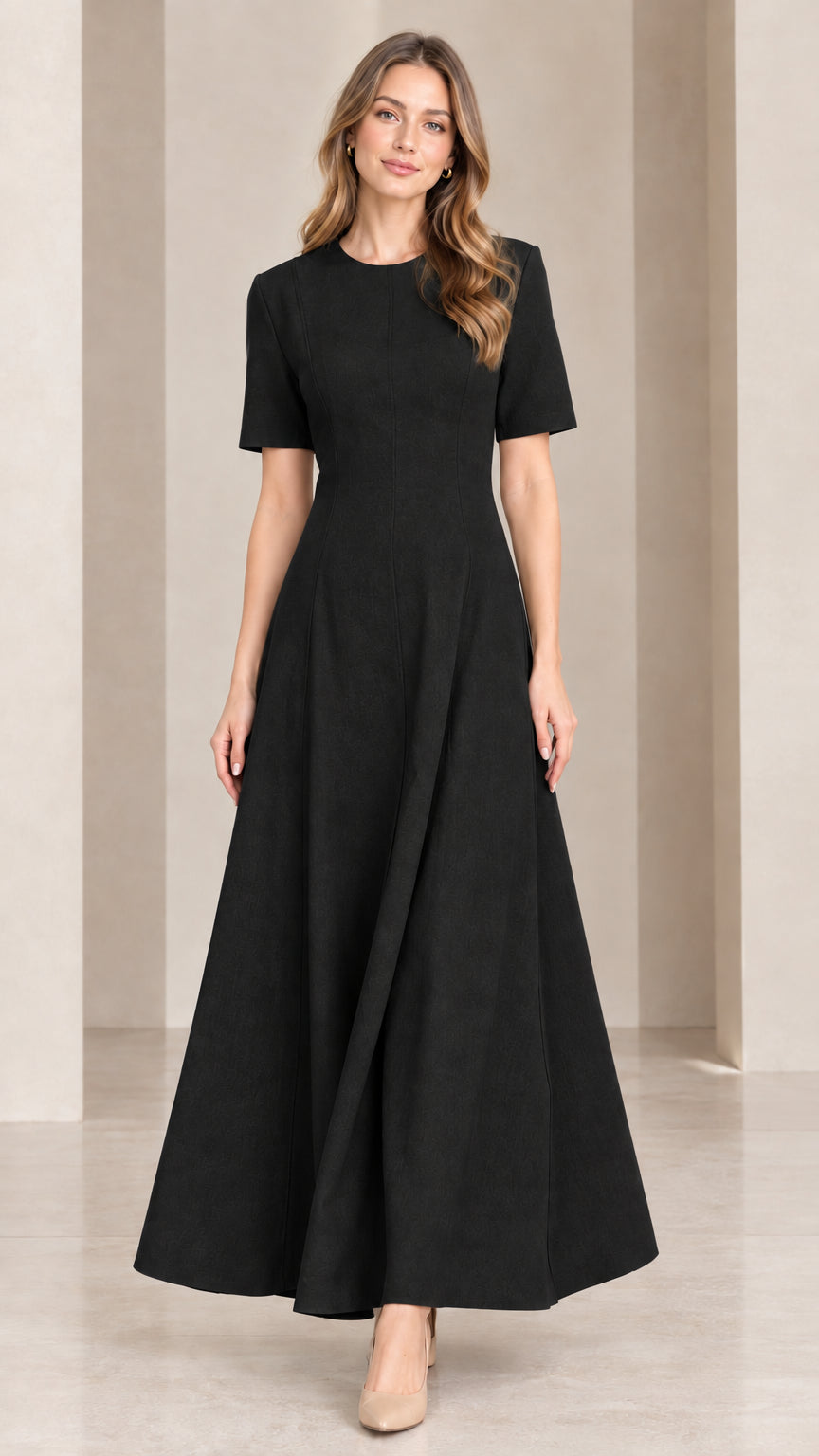 Front view of woman wearing classic black short sleeve A-line maxi dress
