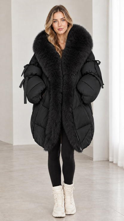 Model wearing black faux fur hooded quilted puffer coat with sleeve bow details
