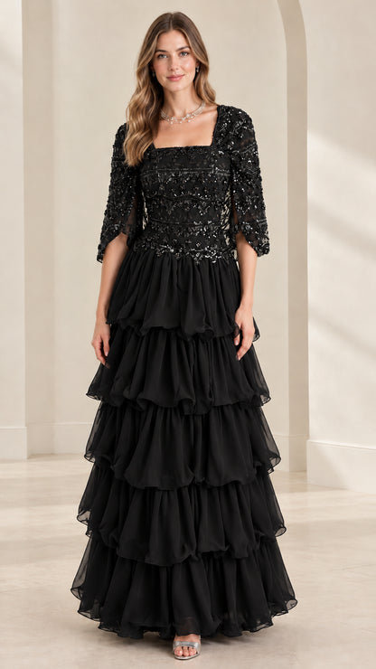Full view of black sequin bodice tiered ruffle maxi formal evening gown