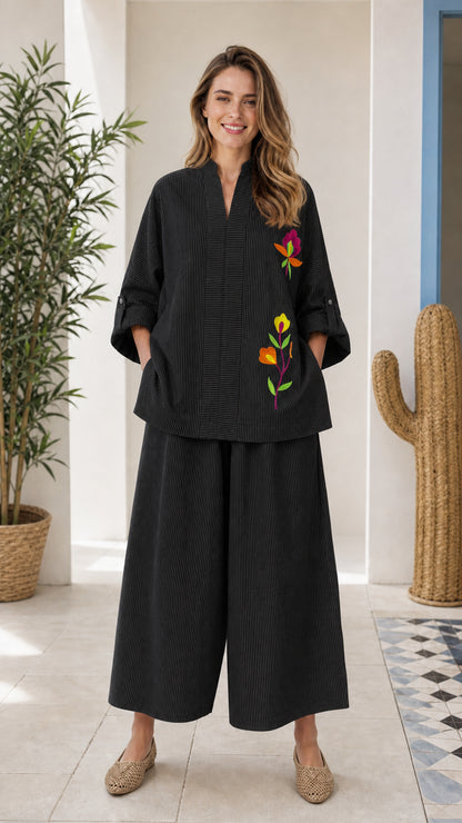 Front view of woman wearing black embroidered two-piece set