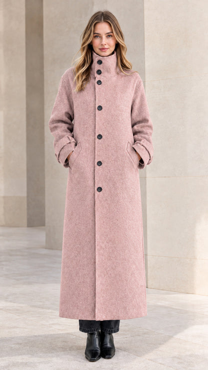 Front view of woman wearing dusty pink long buttoned maxi overcoat