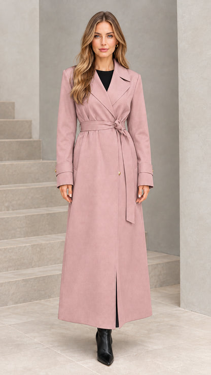 Front view of woman wearing dusty pink maxi belted trench coat