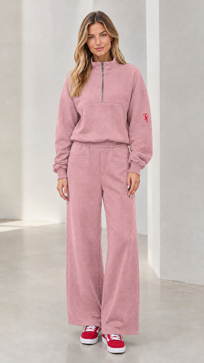 Front view of woman wearing dusty pink half-zip pullover and wide-leg lounge set