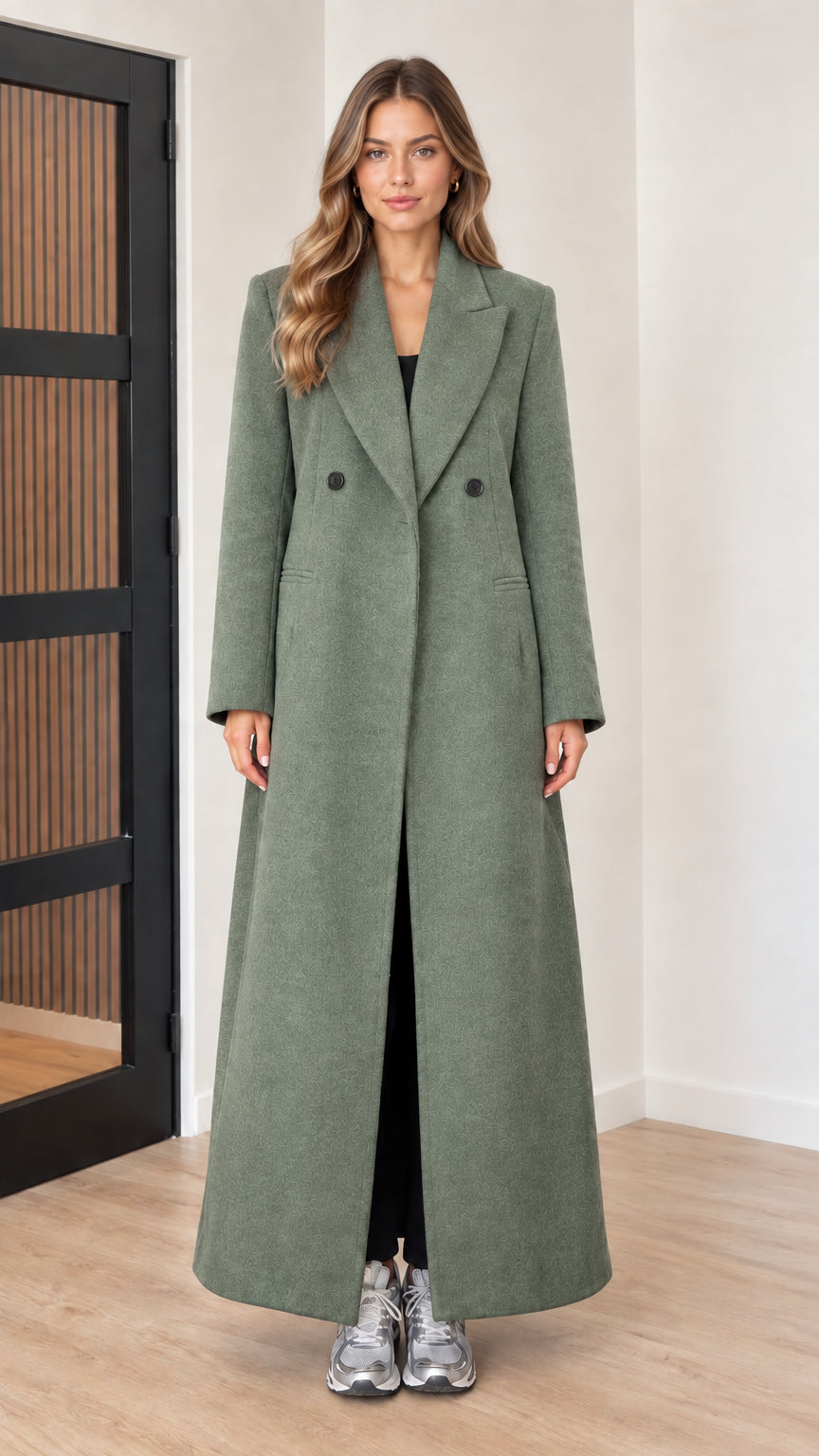 Front view of woman wearing sage green tailored maxi overcoat