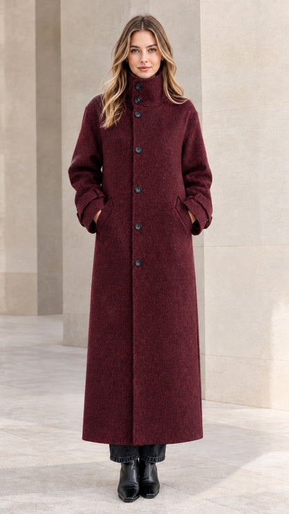 Front view of woman wearing deep burgundy long wool-look coat with stand collar