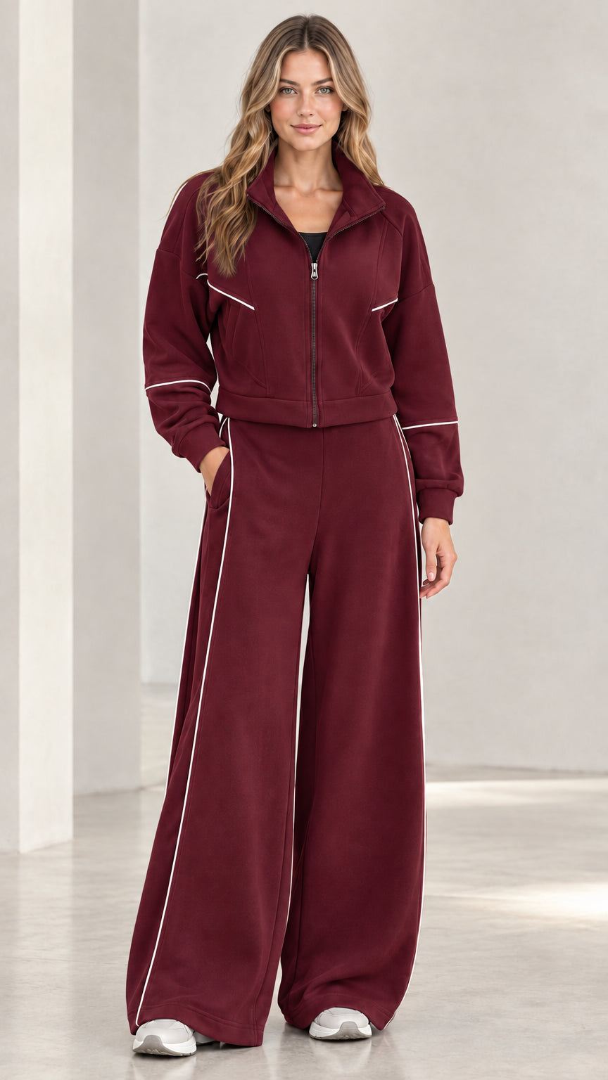 Front view of woman wearing burgundy contrast piping wide leg tracksuit set