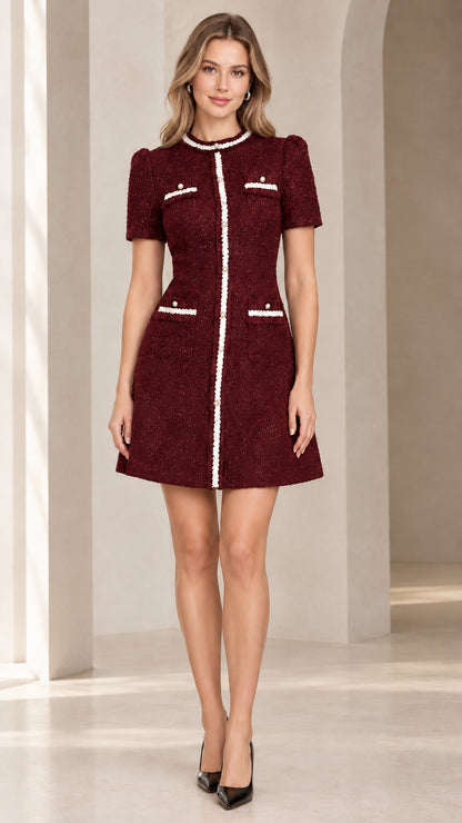 Front view of model wearing burgundy short sleeve tweed mini dress with white trim