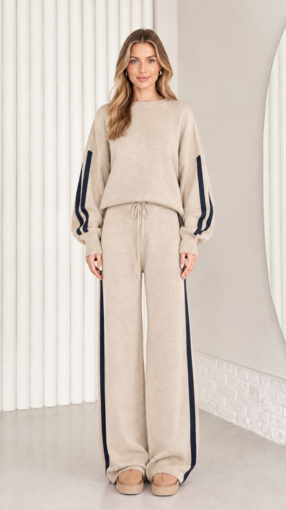 Front view of model wearing beige oatmeal knit two-piece lounge set with navy stripes