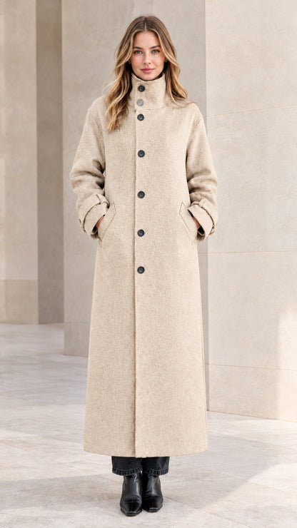 Front view of woman wearing oatmeal cream full-length button front overcoat