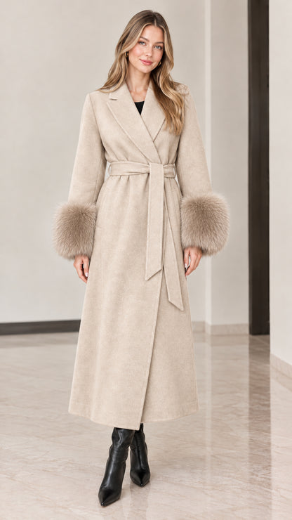 Front view of model wearing beige cream full-length wrap coat with tonal fur cuffs