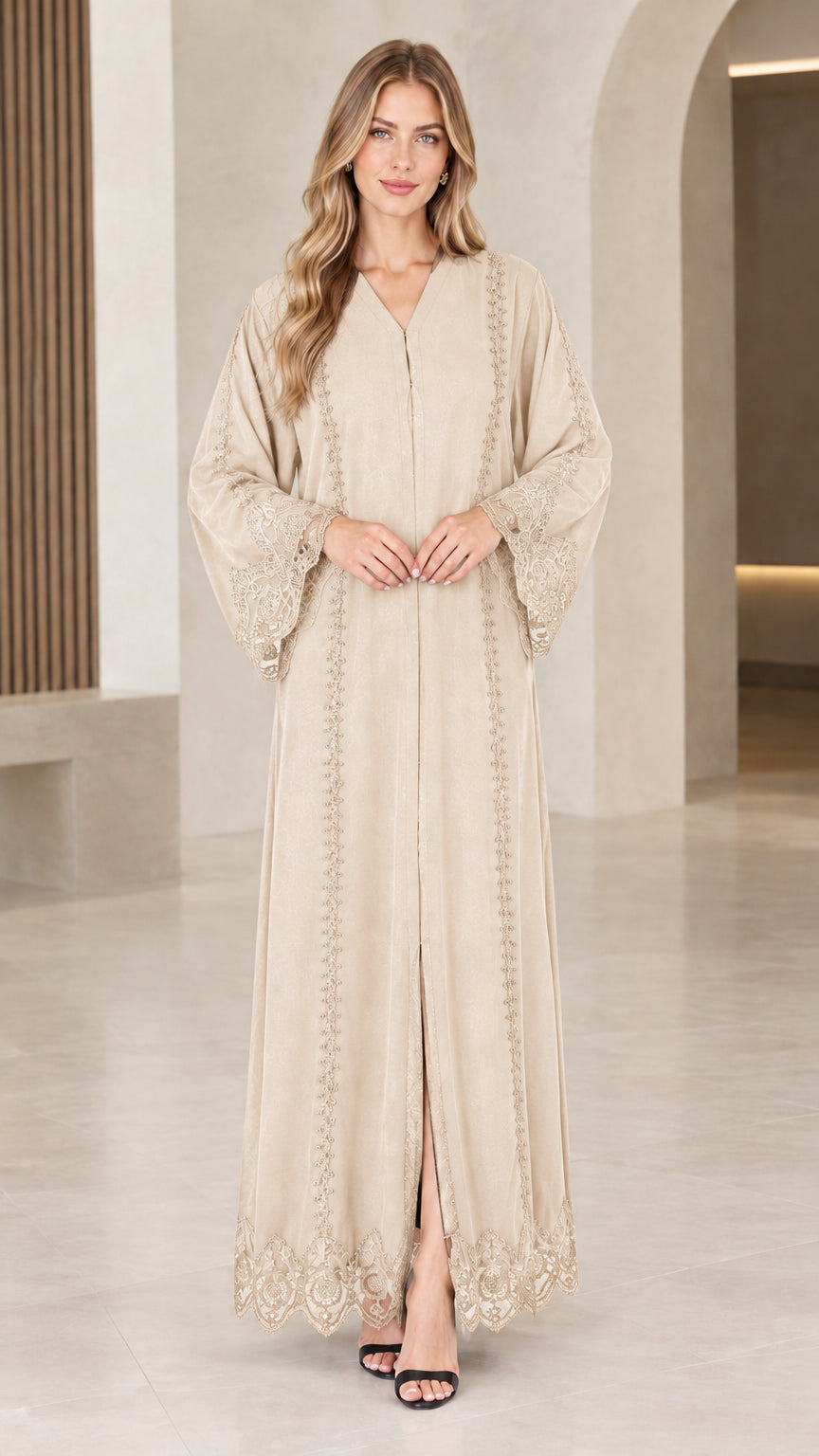 Front view of woman wearing beige champagne lace trim maxi abaya dress