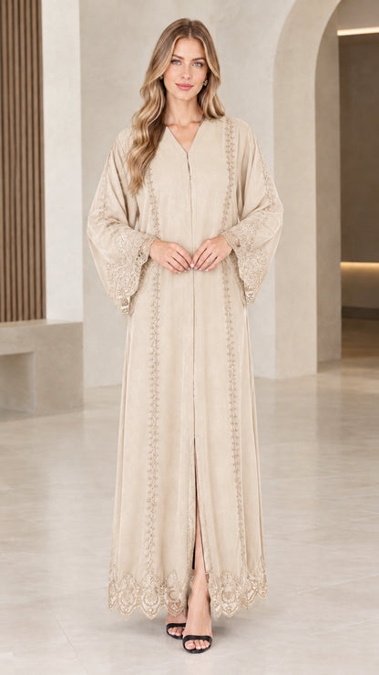 Front view of woman wearing beige champagne lace trim maxi abaya dress