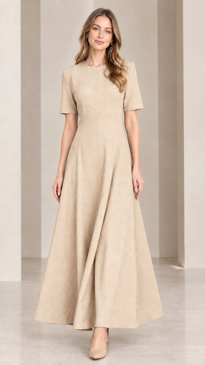 Front view of woman wearing neutral beige short sleeve A-line maxi dress